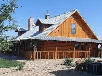 Log cabin style home exterior paint by Padilla Painting